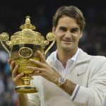 Roger Federer of Switzerland holds the winners trophy after defeating Andy Murray of Britain in their men's singles final tennis match at the Wimbledon Tennis Championships in London July 8, 2012.       REUTERS/Toby Melville (BRITAIN  - Tags: SPORT TENNIS)