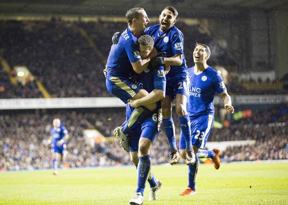 Football - 2015 / 2016 Premier League - Tottenham vs Leicester. Leicester's Daniel Drinkwater and Riyad Mahrez leap on Robert Huth as they they celebrate his goal at White Hart Lane. (Photo by Daniel Bearham/Colorsport/Icon Sportswire) ****NO AGENTS----NORTH AND SOUTH AMERICA SALES ONLY----NO AGENTS----NORTH AND SOUTH AMERICA SALES ONLY****