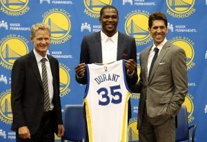 Golden State Warriors' newest player Kevin Durant, center, joins head coach Steve Kerr, left and general manager Bob Myers during a news conference at the NBA basketball team's practice facility, Thursday, July 7, 2016, in Oakland, Calif. (AP Photo/Beck Diefenbach)